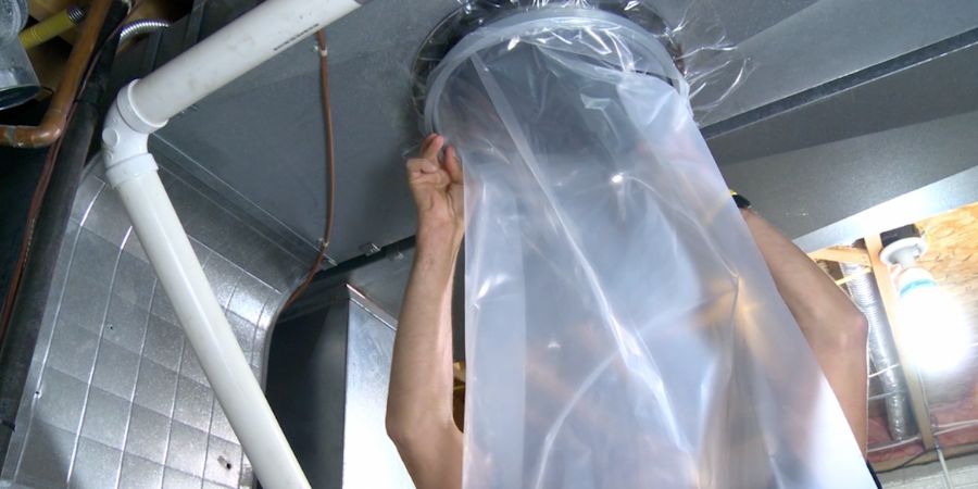 Technician sealing air duct with a plastic